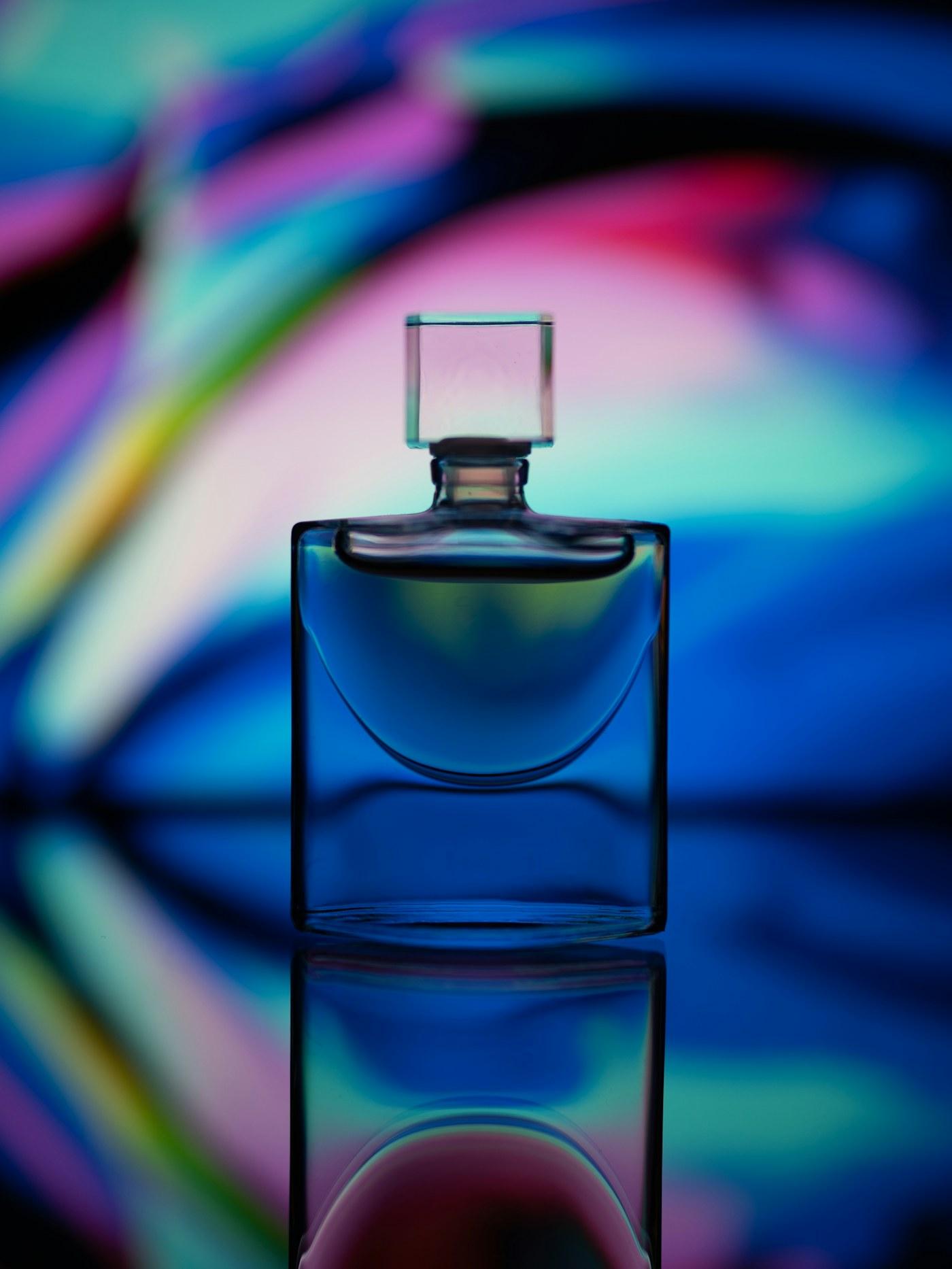 Fragrance bottle in soft pink atmospheric lighting